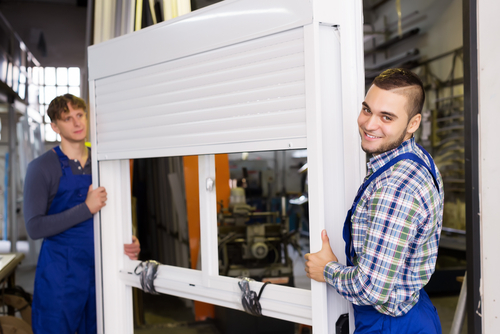 professionals installing an aluminium window shutter