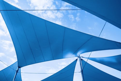 a set of blue Canopy Awnings set against a blue summer sky